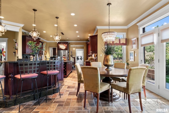 dining space featuring an inviting chandelier and crown molding