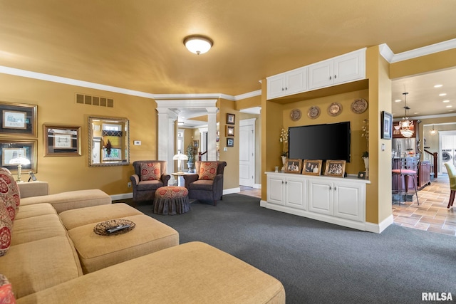 carpeted living room with decorative columns and ornamental molding