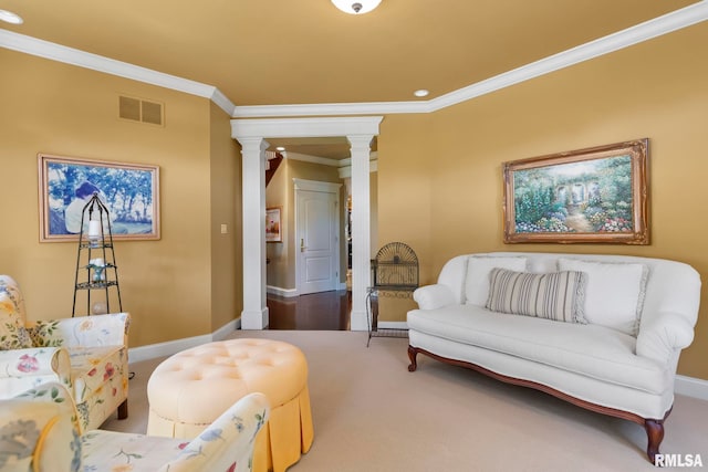 living area featuring carpet flooring, decorative columns, and ornamental molding