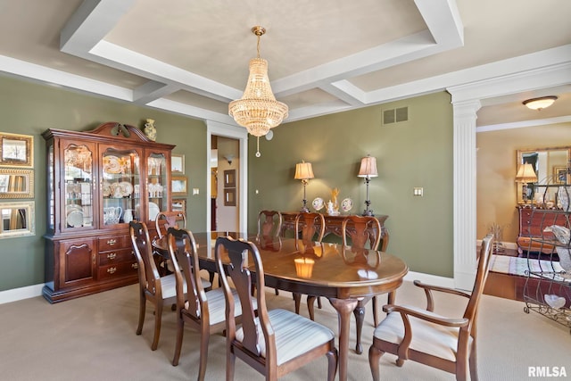 dining space featuring light colored carpet, decorative columns, and a chandelier