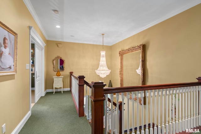 hallway featuring crown molding, dark colored carpet, and a notable chandelier