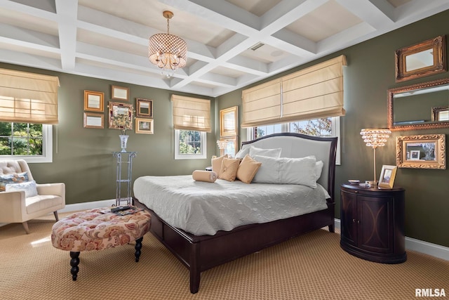 carpeted bedroom with multiple windows, beam ceiling, coffered ceiling, and an inviting chandelier