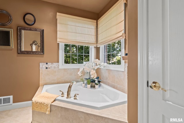 bathroom featuring tile patterned flooring and a relaxing tiled tub