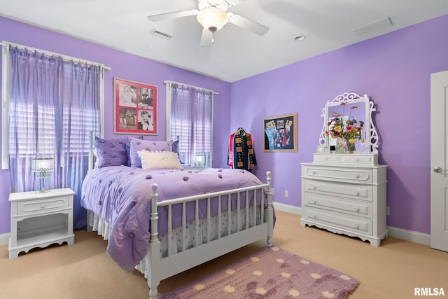 carpeted bedroom with ceiling fan and multiple windows