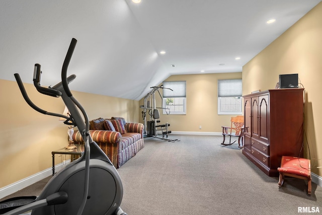 workout room featuring lofted ceiling and light colored carpet