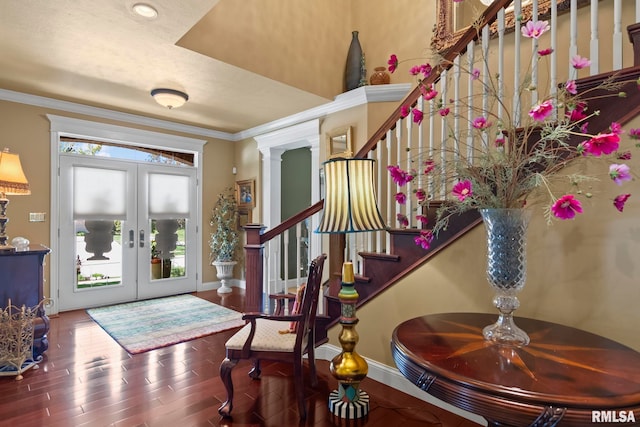 foyer with wood-type flooring, crown molding, french doors, and ornate columns