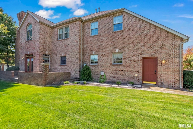 back of property featuring a lawn