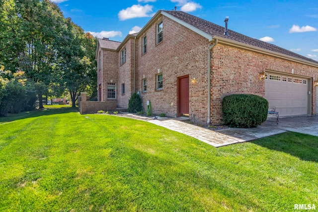 view of home's exterior with a lawn and a garage