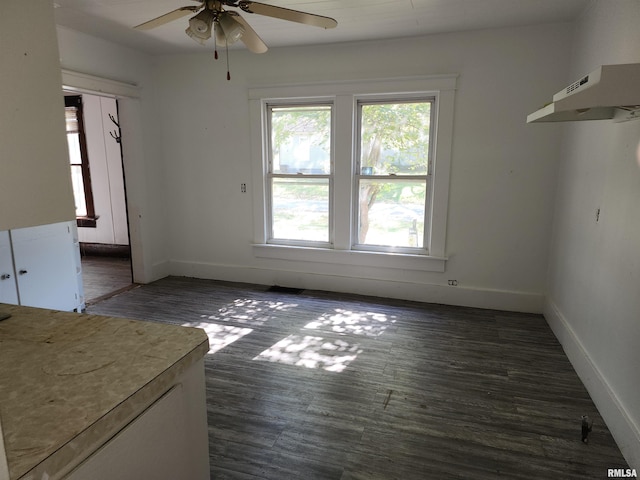 unfurnished dining area featuring ceiling fan and dark hardwood / wood-style floors