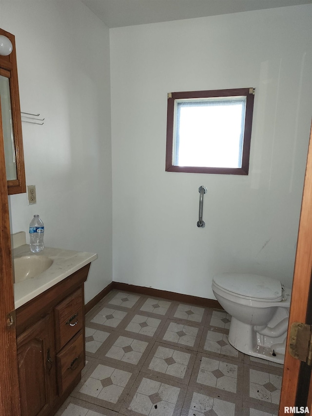 bathroom with vanity, toilet, and tile patterned floors