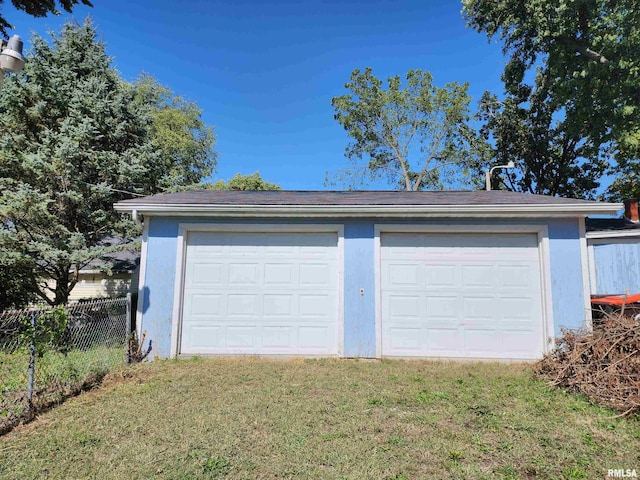 garage featuring a lawn