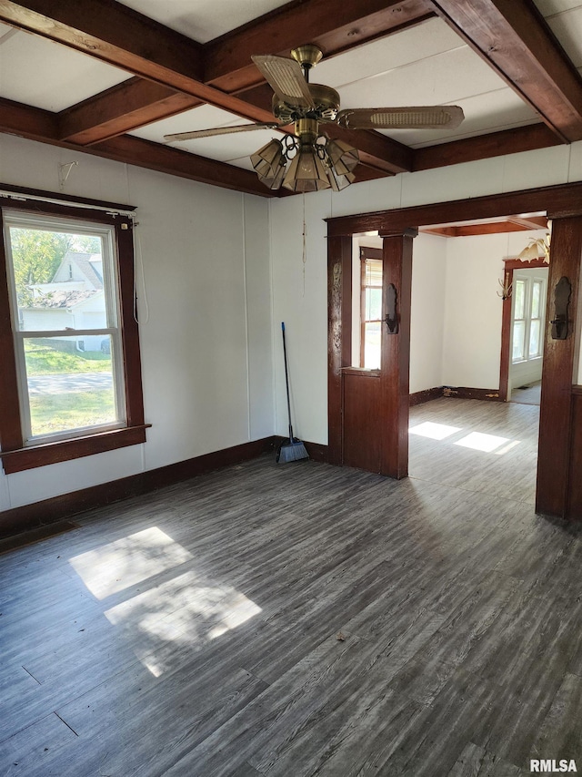 unfurnished room with ornate columns, dark hardwood / wood-style flooring, beamed ceiling, and ceiling fan