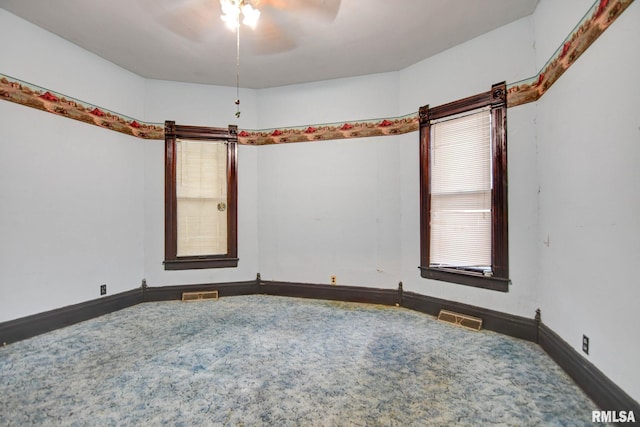 unfurnished room featuring visible vents and baseboards