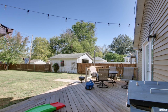 wooden terrace featuring grilling area and a lawn