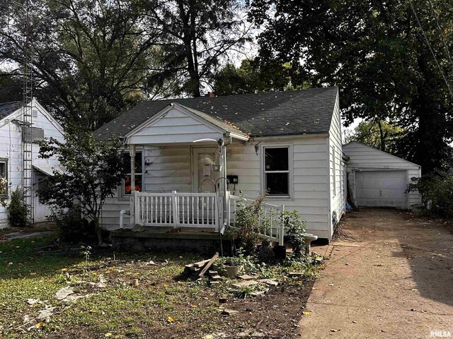 bungalow-style house with an outdoor structure, a garage, and covered porch