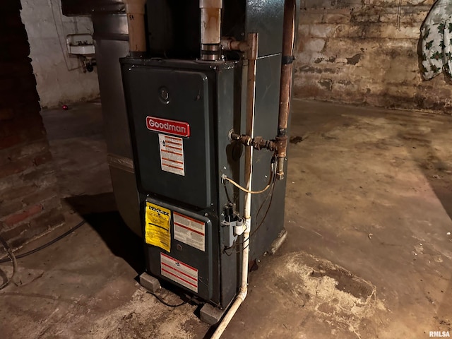 utility room featuring heating unit