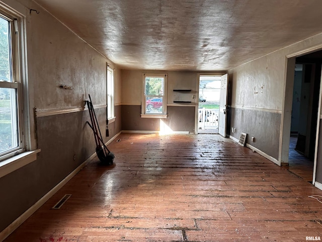 empty room with hardwood / wood-style flooring