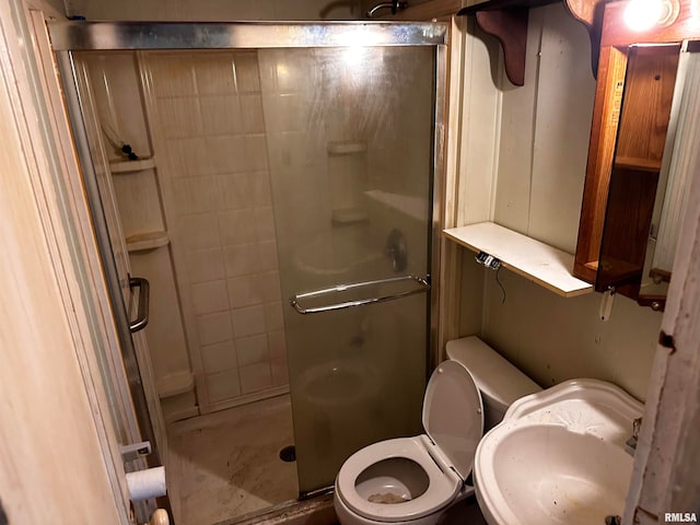 bathroom with sink, a shower with shower door, and toilet