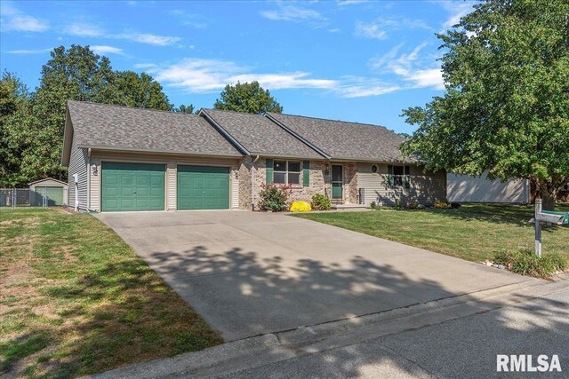 single story home featuring a front yard and a garage