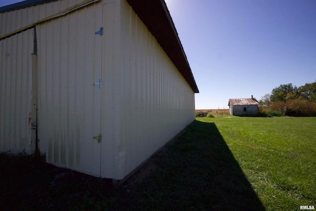 view of property exterior featuring a storage shed and a lawn