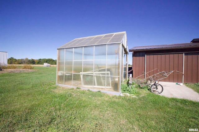 view of outbuilding with a yard