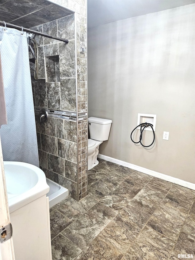 bathroom featuring vanity, toilet, and a shower with curtain