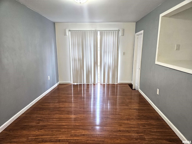 spare room with dark wood-type flooring