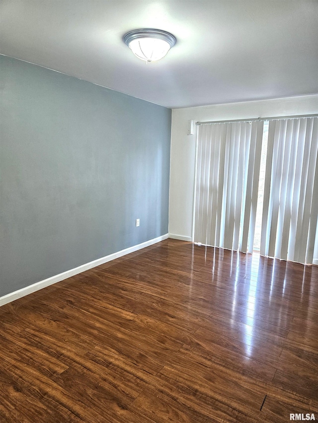 spare room with dark wood-type flooring