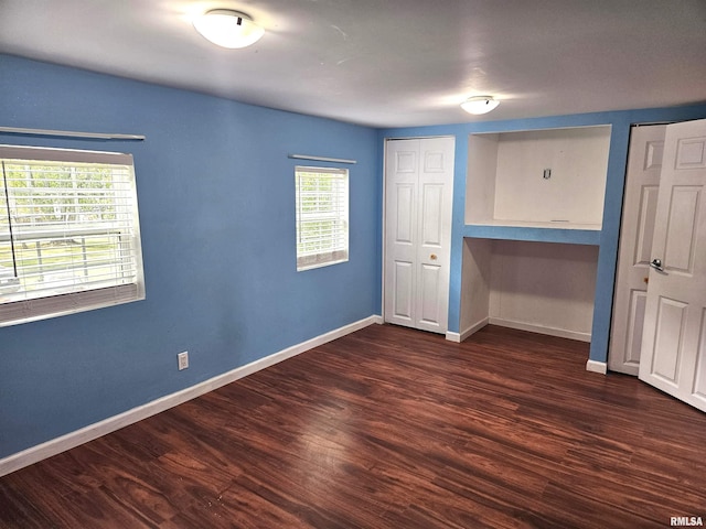 unfurnished bedroom featuring dark wood-type flooring