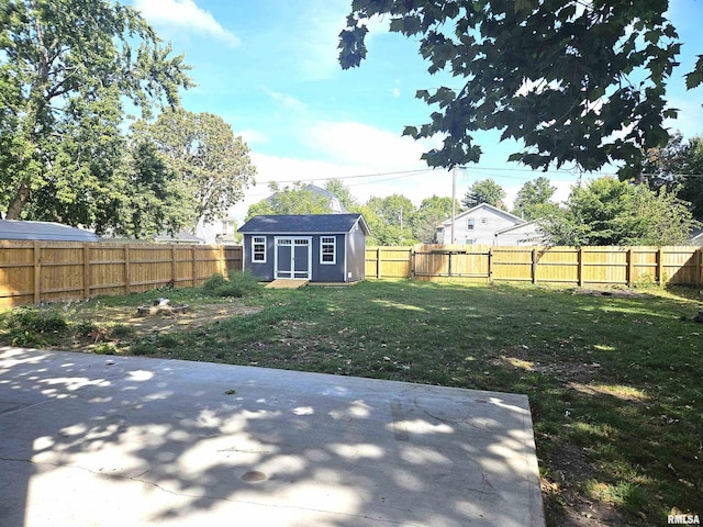 view of yard with a storage unit and a patio area