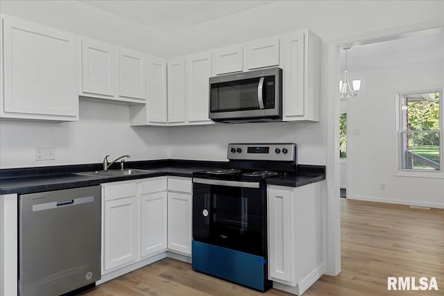 kitchen featuring stainless steel appliances, light wood-type flooring, and white cabinetry