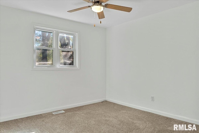 spare room with ceiling fan and carpet