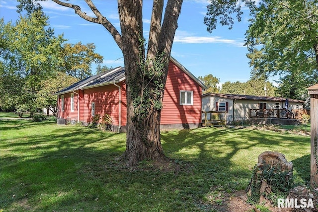 view of side of home featuring cooling unit and a lawn