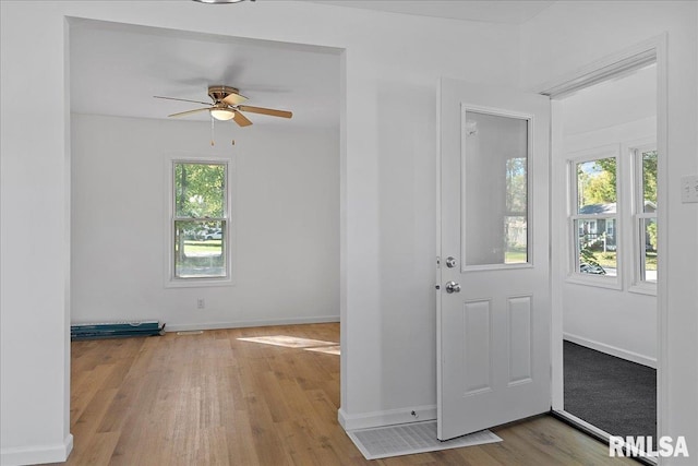 entryway with ceiling fan, plenty of natural light, and light hardwood / wood-style floors