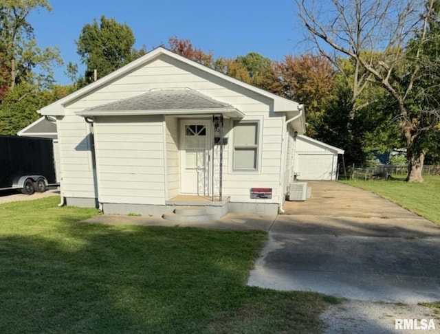 view of front of property with central AC and a front yard