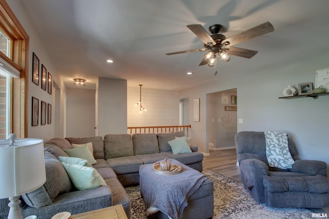 living room featuring light hardwood / wood-style floors and ceiling fan