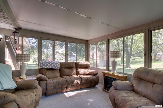 sunroom / solarium with a fireplace