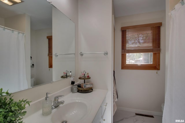 bathroom featuring vanity and toilet