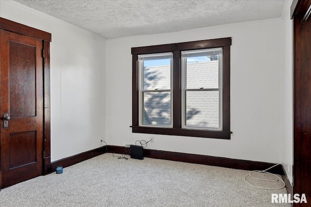 carpeted empty room with a textured ceiling