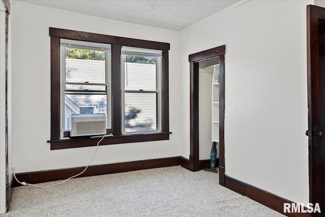 carpeted empty room with cooling unit and a textured ceiling