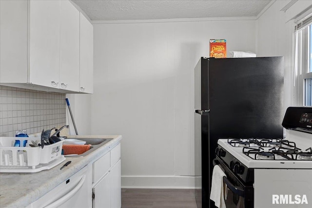 kitchen with sink, dark hardwood / wood-style floors, white appliances, decorative backsplash, and white cabinets