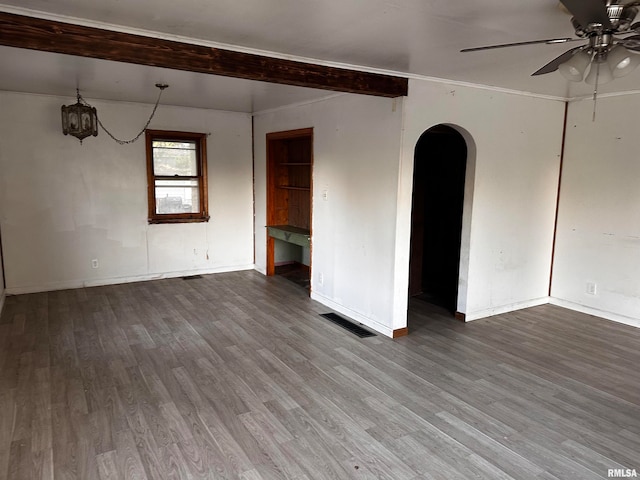 spare room with wood-type flooring, beam ceiling, and ceiling fan