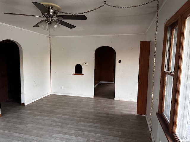 unfurnished room featuring wood-type flooring, plenty of natural light, ornamental molding, and ceiling fan