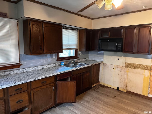 kitchen featuring ceiling fan, crown molding, light hardwood / wood-style flooring, sink, and light stone counters