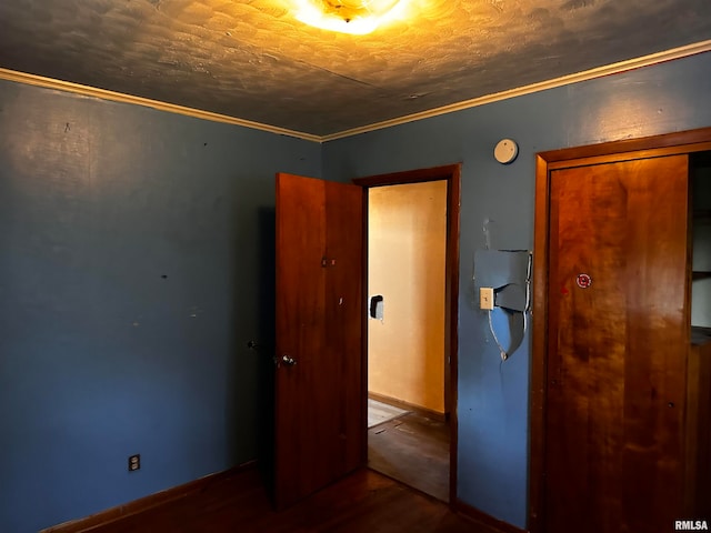 unfurnished bedroom featuring ornamental molding and hardwood / wood-style floors