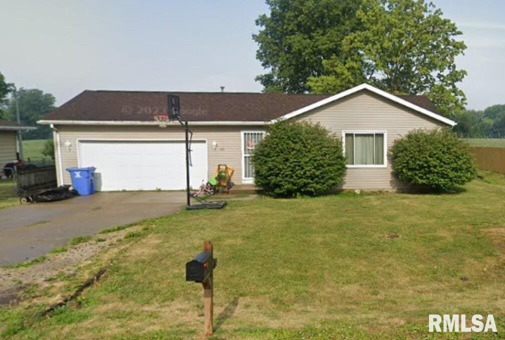 ranch-style house with a front yard and a garage