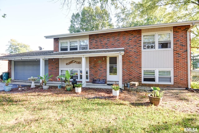 view of front facade with a garage, ceiling fan, a front yard, and covered porch