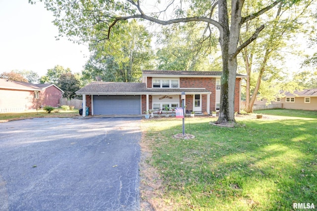 view of front of house with a garage and a front lawn