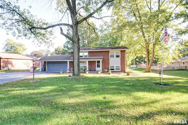 view of front of property with a front yard and a garage