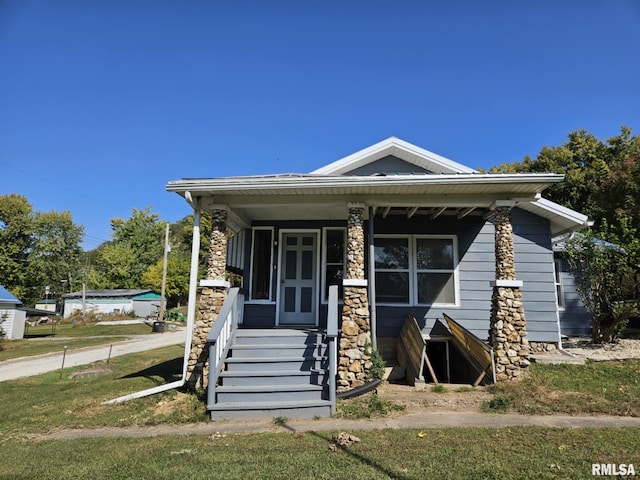 bungalow-style house with a front yard